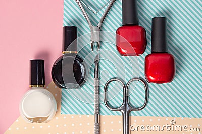 Tools for manicure on a pink and blue background. Nail files, scissors and nail polishes top view. Nail Salon Stock Photo