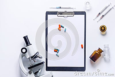 Tools for medical tests microscope and syringe on white background top view copyspace Stock Photo