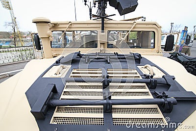 Tools mounted on the hood of a Humvee military vehicle - hammer, axe, shovel and pickaxe Editorial Stock Photo