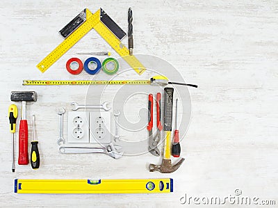 Tools shape of house, Home improving, repair concept. Wooden background Stock Photo