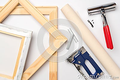 Tools for stretching a canvas with a photo on a wooden stretcher. Top view Stock Photo