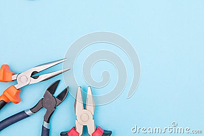 Tools worker, different pliers on blue background, top view with free space Stock Photo