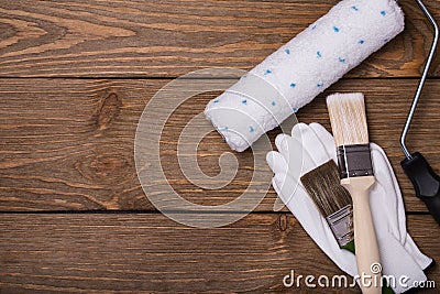 Tools for working with paint. Brush, roller and gloves Stock Photo