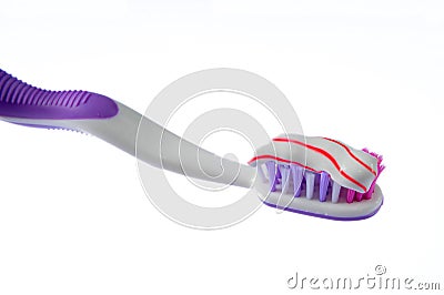 Toothbrush covered by toothpaste isolated on white Stock Photo