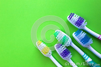 Five toothbrushes lie on a green background Stock Photo