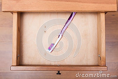 Toothbrush in open drawe Stock Photo