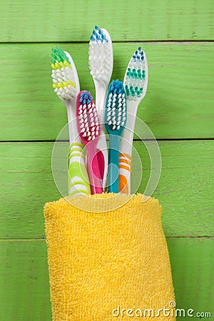 Toothbrushes on the green wooden background Stock Photo