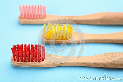 Toothbrushes made of bamboo on light background, closeup Stock Photo