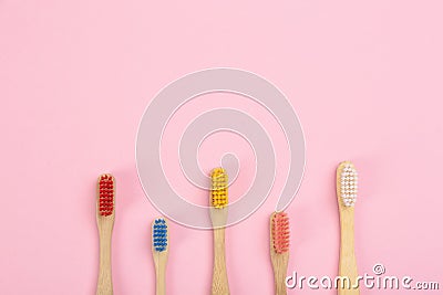 Toothbrushes made of bamboo on pink background. Space for text Stock Photo