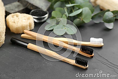 Toothbrushes made of bamboo on stone table Stock Photo