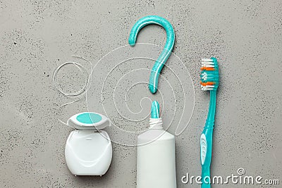 Toothpaste in the form of a question mark and toothbrushes and dental floss. Concept of how to choose the right toothbrush or how Stock Photo