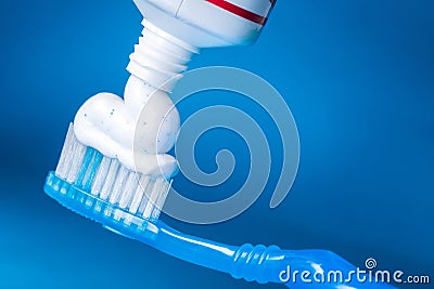 Toothpaste on a toothbrush close-up on background Stock Photo