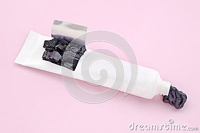 Toothpaste tube with solid and liquid black natural cosmetic activated charcoal or volcanic clay with scrub effect Stock Photo