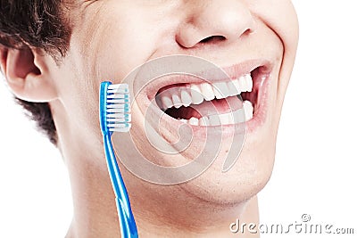 Toothy smile with brush closeup Stock Photo