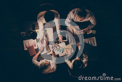 Top above high angle view of four smart clever hardworking business people executive managers preparing strategy report Stock Photo