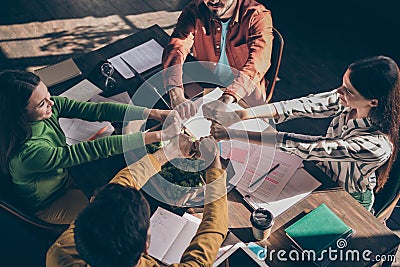 Top above high angle view photo of cheerful people creating big united team to get through work difficulties together Stock Photo