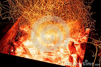 Top above overhead detail view od abstract hot red burning wooden coal background in bbq grill brazier or firepit at Stock Photo