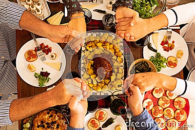 Top and above view on a big table and people eating and praying and thanking at god or someone about thei food Stock Photo