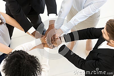 Top above view diverse business people stacked hands Stock Photo