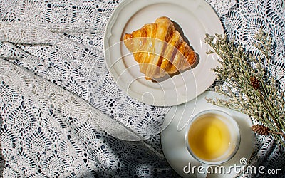 Top or aerial view croissant and cup of tea or coffee served for breakfast in the morning at comfortable home on table with white Stock Photo