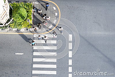 Top aerial view people walk on across pedestrian at the outdoor pedestrian concrete ground Editorial Stock Photo