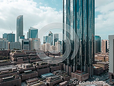 Top aerial view shot of skyscrapers in a modern city with fog clouds passing by - Downtown Abu Dhabi landmarks and World Trade Cen Stock Photo