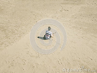 Top aerial view of young hipster sitting on the abstract sandy sea beach. summer exotic concept d Stock Photo