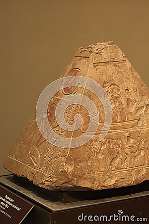 The top of an ancient Egyptian funerary pyramid depicting the god Ra sitting in a boat. Close-up Editorial Stock Photo