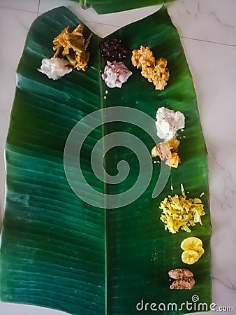 Top angle shot of onam sadhya in kerala style with curries in a banana leaf. Stock Photo