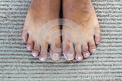 top of asian man barefoot Stand on the messy cement floor Stock Photo