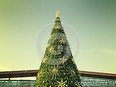 The top of the Christmas tree with a filtered sky in the background in Moscow, Russia Stock Photo