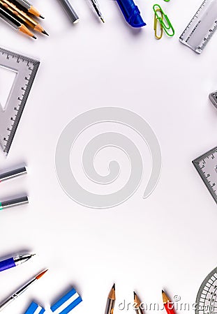 Top close up shot of geometrical instruments with pencils, eraser, binder clips and ruler on white surface Stock Photo