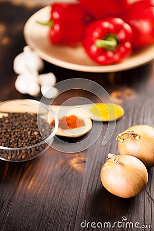 Top close up view on onions with different vegetables blurred on Stock Photo