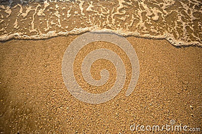 The top corner of the beach has a sea of water coming to the shore Stock Photo