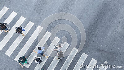 the From the top crosswise view of people walk on street pedestrian crossroad in the city street ,bird eye view. Stock Photo