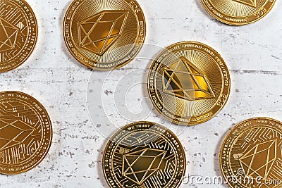 Top down detailed view, golden commemorative EOS - EOSIO cryptocurrency - coins on white stone board Stock Photo