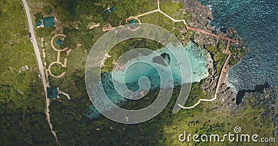 Top down of limpid turquoise lake with designed ways on green valley in aerial. Nobody Asia nature Stock Photo