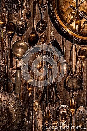 A top down view of an abstract arrangement of antique cutlery and utensils with a bronze tint. Stock Photo