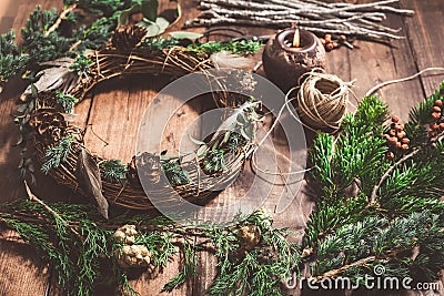 Top down view of florist's worktable. Making of festive wreath for autumn or Christmas Stock Photo