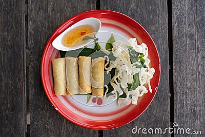 Top down view of four Thai springrolls on a traditional plate Stock Photo