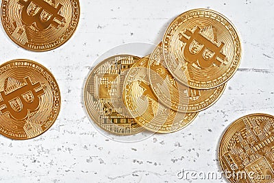 Top down view, golden commemorative btc - bitcoin cryptocurrency - coins scattered on white stone board, closeup detail Stock Photo