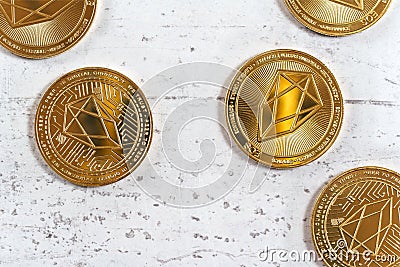 Top down view, golden commemorative EOS - EOSIO cryptocurrency - coins scattered on white stone board Stock Photo