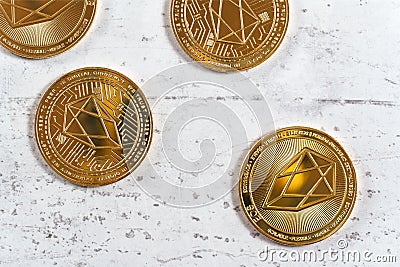 Top down view, golden commemorative EOS - EOSIO cryptocurrency - coins on white stone board Stock Photo