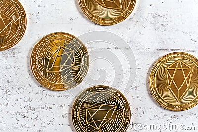 Top down view, golden commemorative EOS - EOSIO cryptocurrency - coins on white stone board Stock Photo