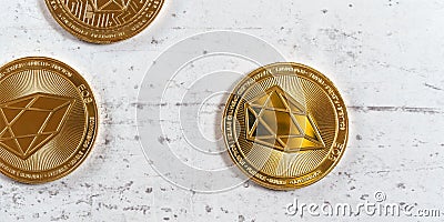 Top down view, golden commemorative EOS - EOSIO cryptocurrency - coins on white stone board Stock Photo