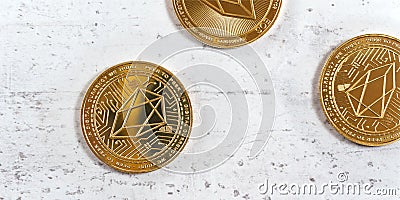 Top down view, golden commemorative EOS - EOSIO cryptocurrency - coins on white stone board Stock Photo