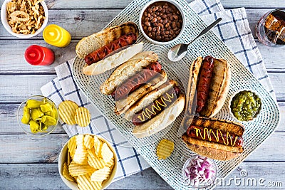 A top down view of gourmet hotdogs surrounded by all the fixings. Stock Photo