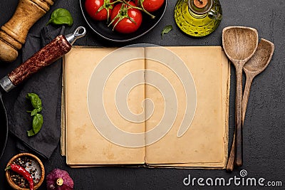 Top-down view of a kitchen table with ingredients, utensils, and an open cookbook Stock Photo