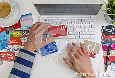 Top down view of online shopping using gift cards Editorial Stock Photo