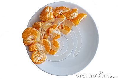 Top down view of pealed mandarin peaces on white plate on white background Stock Photo